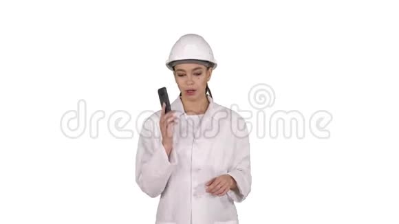 女工程师一边打电话一边走在白色背景上视频的预览图