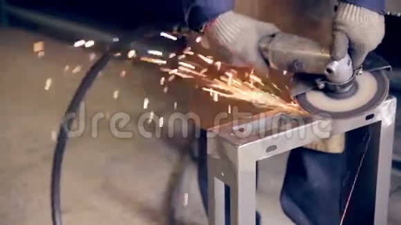 在工业工厂工厂的金属零件上使用工业磨床的工人视频的预览图