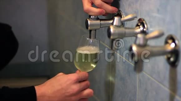 一个男人手杯子里倒着白葡萄酒的特写镜头视频的预览图