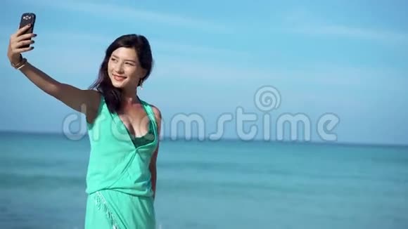 旅行女孩在海滩上打电话自拍视频的预览图