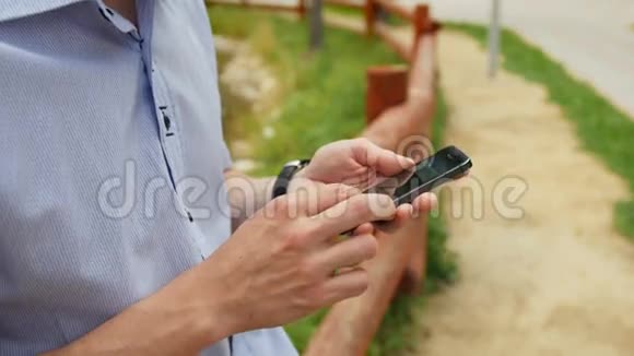 人在公园使用手机智能手机iphon风格视频的预览图