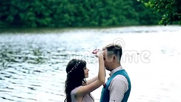 男人和女人年轻快乐的夫妇在湖边视频的预览图
