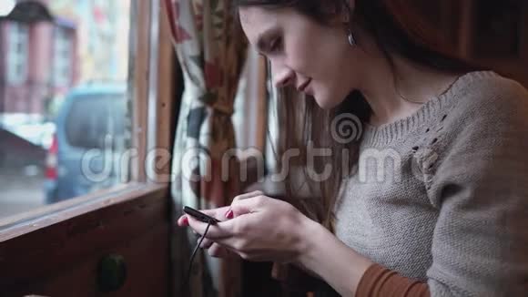 特写肖像现代咖啡馆4k的女士使用智能手机触摸屏视频的预览图