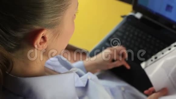 漂亮的女孩在电脑上写文件视频的预览图