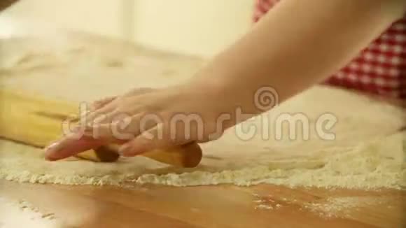 面包师用擀面杖揉面团女人用面团做披萨做披萨的面团滚动面团视频的预览图