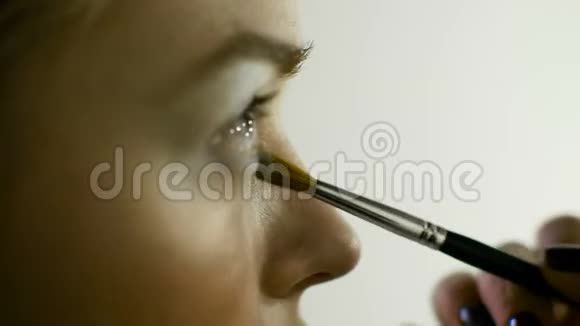 化妆大师描绘了女孩的眼睛化妆特写视频的预览图