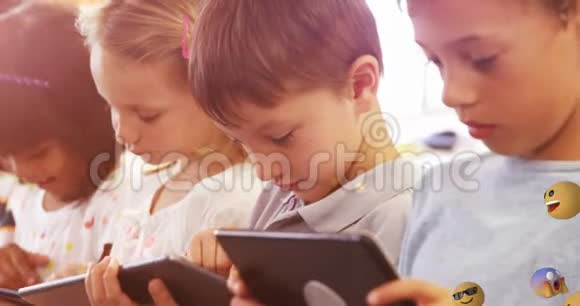 emoji图标与学童使用平板电脑的背景4k视频的预览图