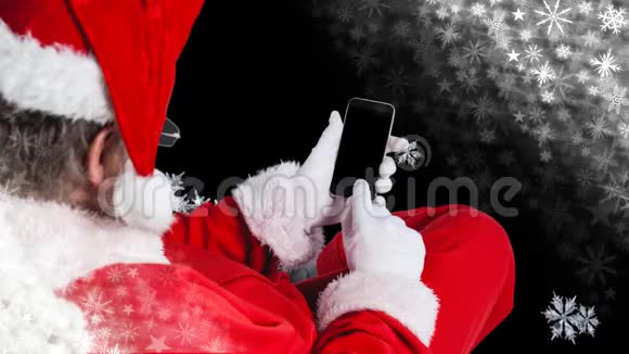 圣诞老人用手机雪花飘落视频的预览图