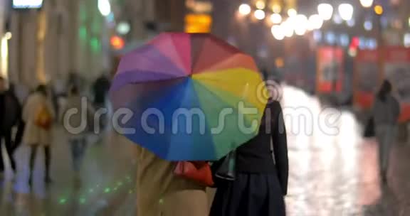 雨夜城市在五颜六色的伞下漫步视频的预览图