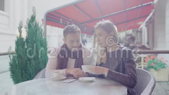恋爱中的情侣在户外咖啡馆的浪漫约会中喝咖啡视频的预览图