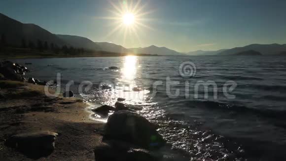 在山湖的岩石海岸上日落蒙古霍顿湖视频的预览图