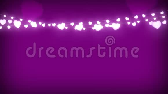 粉红色背景上闪烁的一串仙女灯视频的预览图