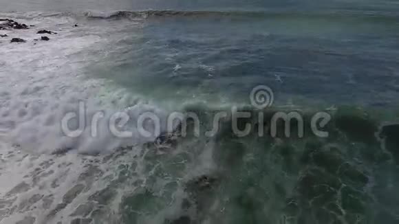 在阳光明媚的夏日在4k空中海滩海景的白色海浪中冲浪视频的预览图