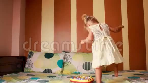 小金发女孩在沙发上围着新玩具跳舞视频的预览图