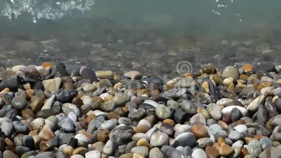在五彩抛光的石头和卵石上冲浪视频的预览图