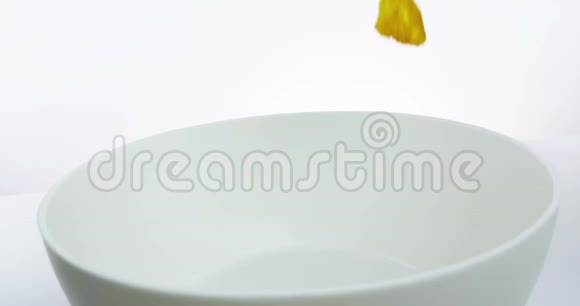 白色背景下的谷物玉米片倒在碗里饮食健康食品的概念视频的预览图