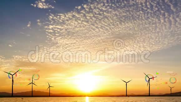 在太阳落山的时候有云天的风力涡轮机视频的预览图