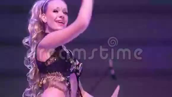 穿着黄色黑色印度西装在舞台上跳舞的女孩视频的预览图