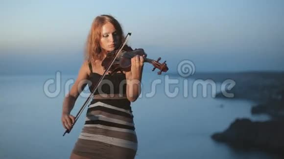女孩拉小提琴住在美丽的附近视频的预览图