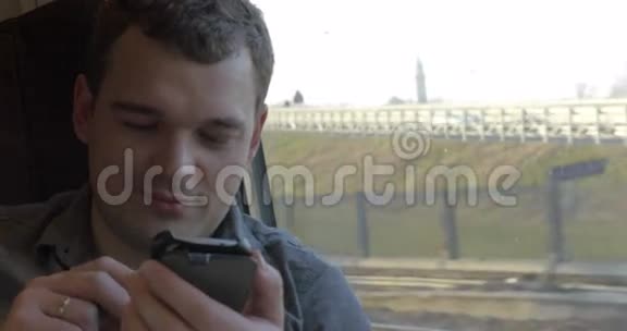 坐火车时男人在手机上聊天视频的预览图