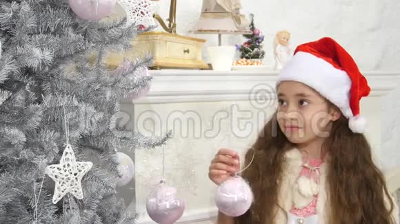 快乐微笑的小女孩装饰新年树视频的预览图