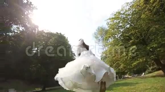 新郎新娘在阳光明媚的公园里拥抱视频的预览图