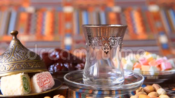 土耳其茶从金属茶壶中倒入传统菜肴视频的预览图