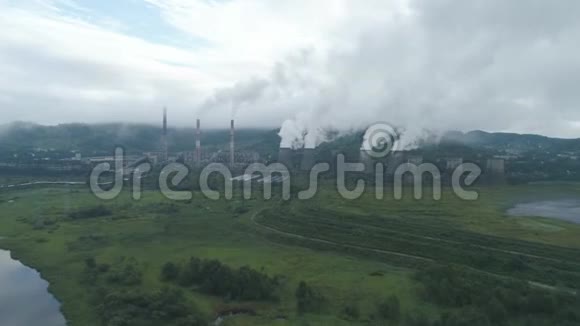 煤热电厂烟管和冷却塔的空中无人机视图热电站排汽视频的预览图