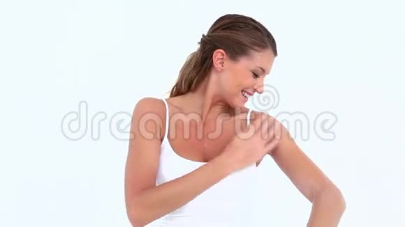微笑的女人在手臂上涂抹保湿霜视频的预览图