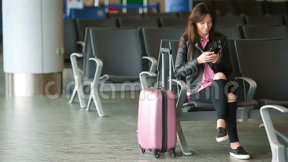 航空公司乘客在机场休息室等待航班飞机在候诊室找时间的白人女人视频的预览图
