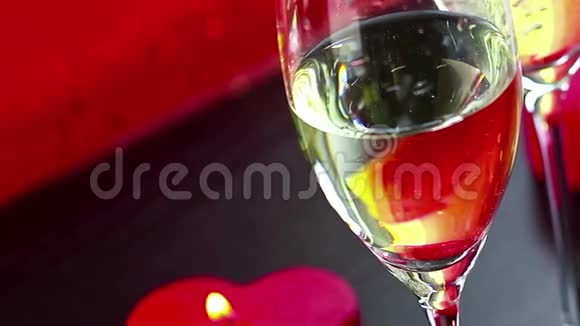 在红烛燃烧爱情和情人节的概念附近喝香槟酒视频的预览图