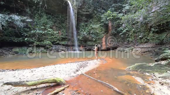 婆罗洲兰比尔山国家公园的热带雨林中一对夫妇游进五彩的自然游泳池瀑布优美视频的预览图