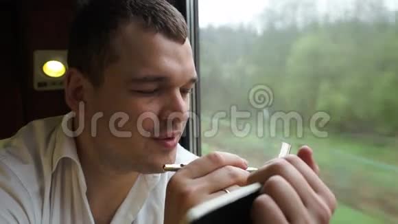 体贴的年轻人在火车上记笔记视频的预览图