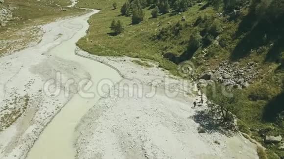 顶景徒步旅行者在背景山河上旅行远足山视频的预览图