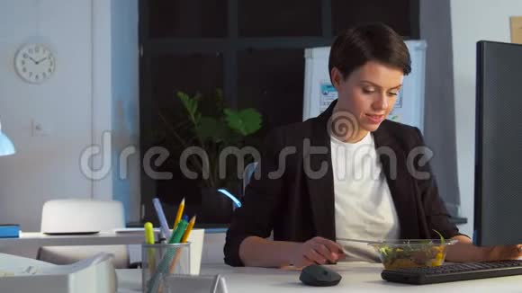 女商人在夜间办公室吃饭和工作视频的预览图