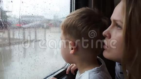 男孩和他的母亲望着火车的窗外视频的预览图