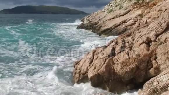 纯净的蓝色水域海洋海岸波浪打破和飞溅冒险海上海岸冲浪岩石录像夏季视频的预览图