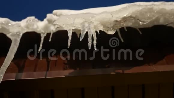 冰柱屋顶悬挂在屋顶在滴水的冬天春天温暖的自然视频的预览图