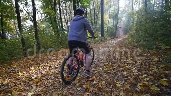 骑自行车的人在森林里经过骑自行车的人在森林里经过慢动作视频的预览图