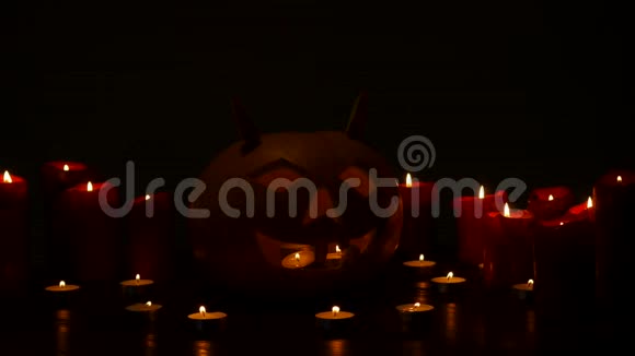 万圣节南瓜灯在黑色背景上燃烧点燃蜡烛视频的预览图