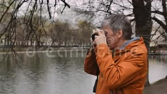 成年男子摄影师用老式相机拍照视频的预览图