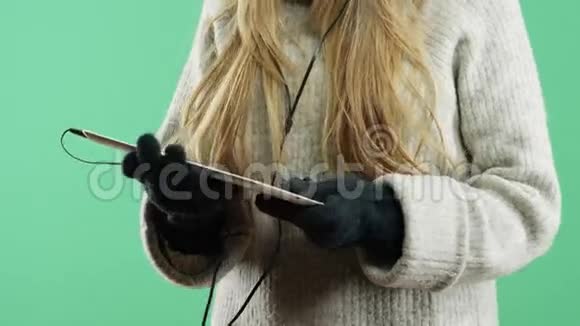 冬天悲伤的女孩用耳机听音乐视频的预览图
