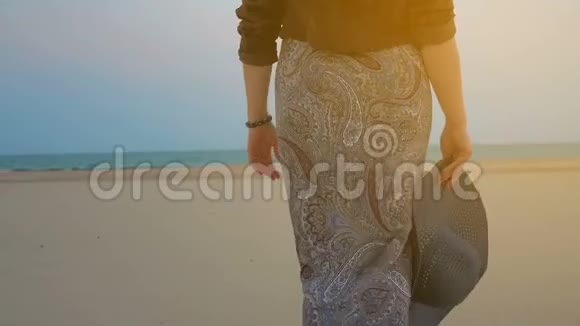夏日傍晚的女人漫步在沙滩上视频的预览图