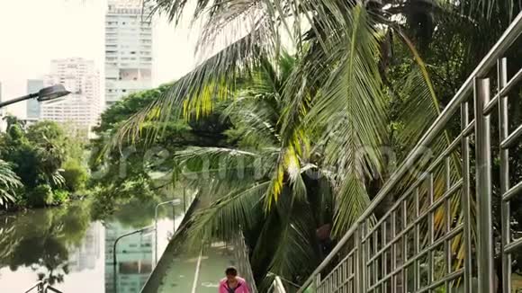早上在人行道上奔跑的年轻亚洲女人年轻的运动亚洲女人在城市楼梯上跑楼上视频的预览图