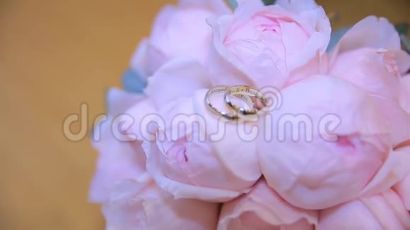 婚礼戒指在一束白色的花上结婚戒指和深蓝色的花束快关门婚礼视频的预览图