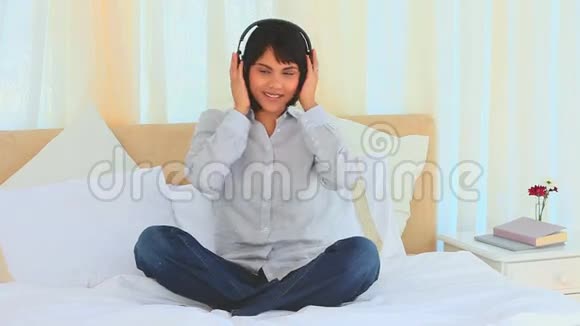 可爱的亚洲女孩听音乐视频的预览图