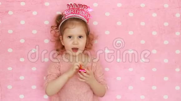 生日快乐有趣的孩子吹党角微笑玩得开心笑和庆祝粉红色的特写肖像视频的预览图