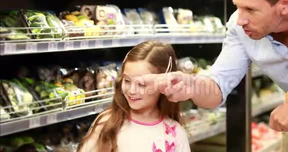爸爸和女儿在超市里挑选沙拉视频的预览图
