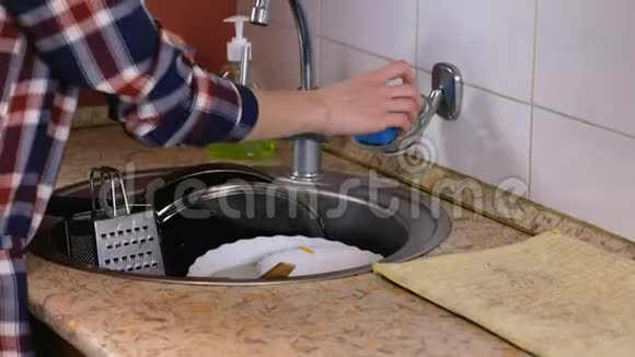 女人在厨房水槽里洗盘子视频的预览图
