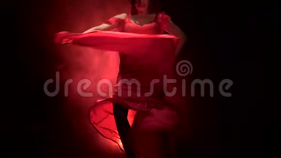 舞者穿着别致的礼服在阿根廷弗拉门戈的燃烧舞蹈中旋转从后面发光烟雾背景慢慢视频的预览图